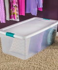 Slay Your Storage Goals With This Badass Set Of Plastic Latching Storage Bins Featuring Secure Snap Lids, Includes 106 Qt And 64 Qt Totes For Closet Decluttering, Garage Organization, And Keeping Bugs At Bay. Clear plastic storage bin with lid, holding textured pillows, in a closet setting.