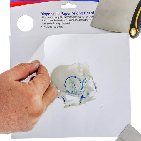 Person peeling sheet from Pro Grade Multi Layered Disposable Paper Body Filler Mixing Board With 100 Sheets, resin surface visible.
