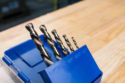 5-piece set of Left Hand Drill Bit For Metal Working With Cobalt M35 Steel Split Point Tips Self Centering Built To Cut Through Hardened Metals Bolts And Studs With Precision Durable Wear Resistant Drill Bit For Tough Jobs in blue holder