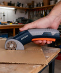 Katerk Cordless Electric Box Cutter With Safety Lock And Led Light cutting cardboard on a workbench with precision.