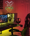 Piranha Plant LED Neon Sign Night Light For Super Mario Fans on wall in gaming room, glowing beside computer setup.