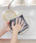 100 Percent Pure Cotton Waffle Weave Dish Cloths 6 Pack Dark Grey being used to wash a glass bowl in soapy water.