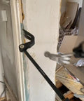 Heavy Duty Indexing Crowbar And Nail Puller Wrecker Tool Boasting Multi Angle Locking Head in action removing trim.