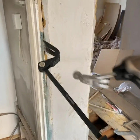 Heavy Duty Indexing Crowbar And Nail Puller Wrecker Tool Boasting Multi Angle Locking Head in action removing trim.