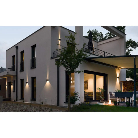 Modern house with Hands Free Sensor LED Dusk To Dawn Outdoor Wall Light 20W Adjustable Aluminum Sconce showcasing warm glow.