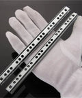 Hand in white glove holding 2 Pack Ball Bearing Drawer Slides 14 Inch Steel Smooth Gliding Furniture Slides For Kitchen Office And Workshop Drawers 342mm Long Heavy Duty Hardware