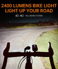 PR2400 2400 Lumen Mountain Bike Light with OLED Runtime Display illuminating a road with high beam and anti glare low beam