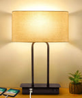 3-Way Dimmable Noiseless Touch Control Table Lamp With 2 USB Ports And AC Power Outlet, modern lamp with fabric shade on table.