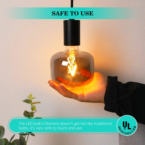 Hand holding lit Large Vintage E26 Edison LED Globe Bulb 20W Equivalent Dimmable 2200K Soft Warm Smoky Gray Glass Conical Design