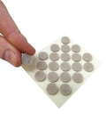 Sheet of 3/8-inch beige round mini self-stick furniture felt pads being peeled, 84-count, for hardwood, tiles, and vinyl surfaces.