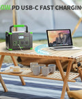 1000W Portable Power Station With 200W Solar Panels for RV and Van Life on a wooden table with laptop and cups, outdoors