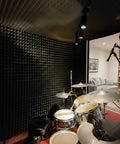 24 Pack Hella Thick Acoustic Foam Panels Crafted To Knock Out Studio Reverb And Quiet Down Busy Rooms For Home Offices Creative Spaces And Relaxing Lounges Premium Density Tiles in a drum studio.