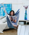 Woman reading in large indoor outdoor hammock chair swing with anti slip steel spread bar heavy duty carbon steel frame holds up to 500 lbs.