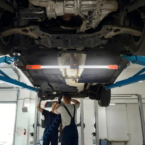 Dope Rechargeable Cordless Underhood Work Light Bar With 2300 Lumens installed under car in garage setting
