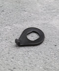 Close-up of single metal 12 Pack M8 M10 Bike Wheel Hub Hook Washer on a gray surface, showing the retaining clip design.