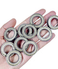 Hand holding 10 precision 6806ZZ ball bearings for robotics and drones