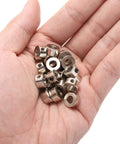 Hand holding twenty piece set screw shaft collars with 5.05mm bore, 10mm OD, 5mm width, nickel plated carbon steel drill stop collars.