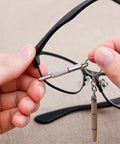 Using the Compact 4 Piece Mini Eyeglass Screwdriver Set With 3 In 1 Flathead And Phillips Drivers on eyeglass frame hinge.