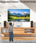Child reaching towards mounted TV above a stylish wooden media console, showcasing Stress Free Install Recessed Tv Media Box Featuring Wifi Friendly Cable Routing Compatible With Roku Apple Fire Stick And Samsung.