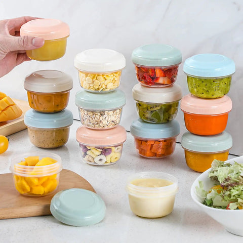 A stack of 16 Pack 4 Ounce Reusable Plastic Jars With Lids For Snacks And Purees On The Go Salad Dressing Containers Deli Storage Freezer Baby Food Containers Dishwasher Safe And BPA Free, in various colors filled with colorful foods.
