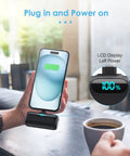 Person using Compact USB C Power Bank With Built In USB C Connector 5000mAh PD Fast Charging Battery Pack, LCD showing 100% charge.