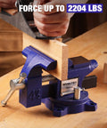 Heavy Duty 4.5 Inch Bench Vise With Multi Jaw For Flat Materials And Pipes Built Tough in use on a workbench holding wood securely.