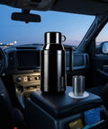 Road Ready Stainless Steel 12V And 24V Car Water Heater Plugs Right Into Cigarette Lighter with cup in car interior.