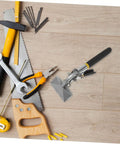 Wooden surface with various hand tools including a saw, pliers, wrench, and the 2 Piece Manual Sheet Metal Seamer Set for edge forming.