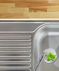 Copper Bathtub Drain Stopper with Push Button Flat Seal installed in a modern sink with a sprouting plant visible.