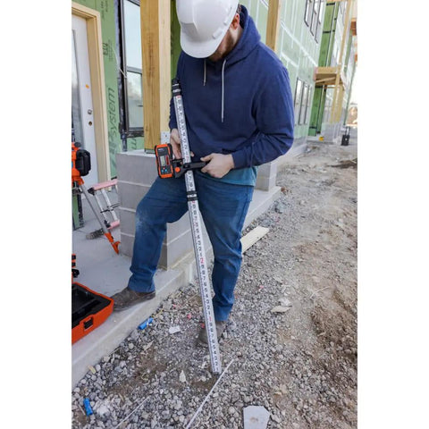 Universal Green and Red Rotary Laser Detector With Dual Sided LED Backlit Display IP54 Dust and Water Protection Fine and Coarse Modes For Precise Leveling And Quick Audible Visual Readouts Pro Grade Easy Read mounted on a laser level rod at construction site