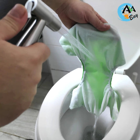 Handheld Hot And Cold Bidet Sprayer With Thermal Grip For Toilet Use cleaning a diaper over a toilet