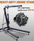 Rock Solid 2 Ton Folding Engine Hoist Cherry Picker Shop Crane Built For Hardcore Garage Swaps Featuring Hella Beefy Steel Frame And 4000 Lb Capacity lifting a car engine with a heavy-duty frame.