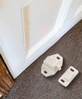 Five Pack Door Roller Catch Set With Spring Loaded Strike In White ABS For Cabinets And Closets, on carpet near door