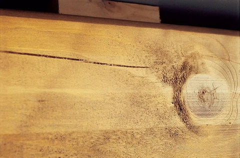 Close-up of weathered wood grain showcasing texture, ideal for applying Premium Elastic Log Stain In Chestnut Shade 5 Gallon Pail.