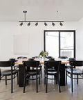 Dining room with Globe Electric 64000123 55" 6-Light Adjustable Height Track Light, Matte Black, installed over table.