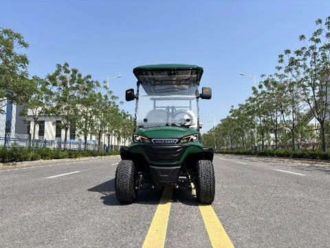 Green Four Seater Electric Golf Cart Patrol Cart Featuring Smooth Independent Suspension And Comfy Bolted Down Seats Built For Lazy Weekend Cruises night time view on a sunny road.