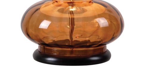 Close-up of amber textured glass base of Casual Table Lamp With Amber Textured Glass Base And Cream Tapered Drum Shade For Cozy Ambient Glow
