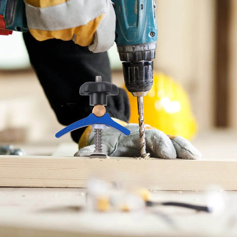 Pro Grade Woodworking T Slot Clamp With Hold Down Function Blue T Track Clip securing wood next to a drill in workshop