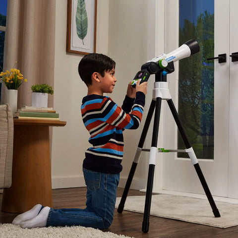 Boy using Totally Kid Friendly Space Explorer Telescope With Two Point Four Inch Video Screen And 110x Zoom Moon Viewing And Adventure Game Digital Telescope For Learning And Outdoor Stargazing indoors