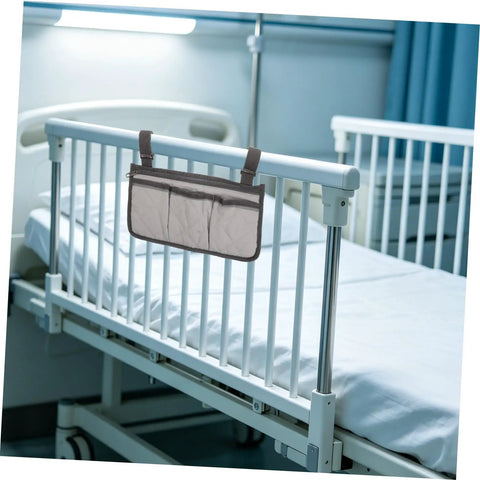 Safety Bed Rail Organizer With Four Pockets And Large Capacity Strap Bag For Nursing Care Beds hanging on a white hospital bed