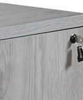 Slick Gray Oak U Shaped Electric Sit Stand Desk With Hassle Free Height Adjustment Includes Overhead Hutch Four Laminate Doors Two Locking File Cabinets And Modesty Panel For A Boss Ready Home Office Setup close-up of gray oak laminate surface and locking file drawer.