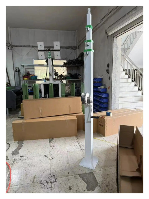 Heavy Duty 30 Foot Telescoping Mast With Manual Hydraulic Electric Lift Options Stainless Steel Construction standing in a workshop.