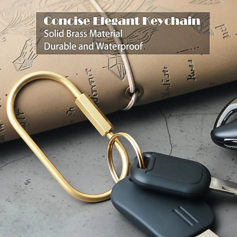 Locking Brass Carabiner Key Rings With Screw Lock Gold Tone Keychain Clip For Keys And Purses next to beige notebook