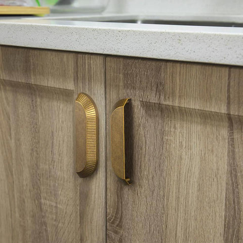 Six Pack 5 Inch Antique Brass Half Moon Cabinet Cup Handles For Kitchen Drawers And Cabinets installed on wooden cabinet.