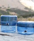 Adjustable Bear Canister For Backpacking And Camping, Expands And Collapses For Bear Resistant Food Storage outdoors on rocks