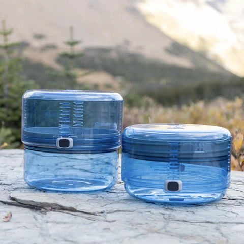 Adjustable Bear Canister For Backpacking And Camping, Expands And Collapses For Bear Resistant Food Storage outdoors on rocks
