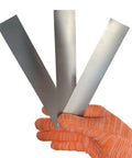 Gloved hand holding 3-piece 304 Stainless Steel Pro Grade Shim Stock Set 1 Inch Wide 6 Inches Long 0.001 0.0015 0.002 Inch Thickness