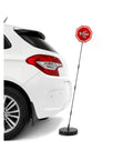 Heavy Duty Led Car Parking Stop Sign With Bright Flashing Warning Light And Rugged Abs Housing next to a white vehicle in driveway.