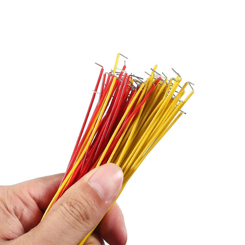 Hand holding red and yellow 560 Piece Jumper Wire Kit For Breadboard Prototyping, 14 Assorted Lengths, Insulated Color Coded Jumpers
