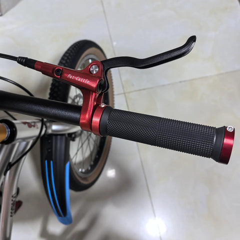 Fat-Cattie red hydraulic brake lever on bicycle handlebar with knurled black grip.